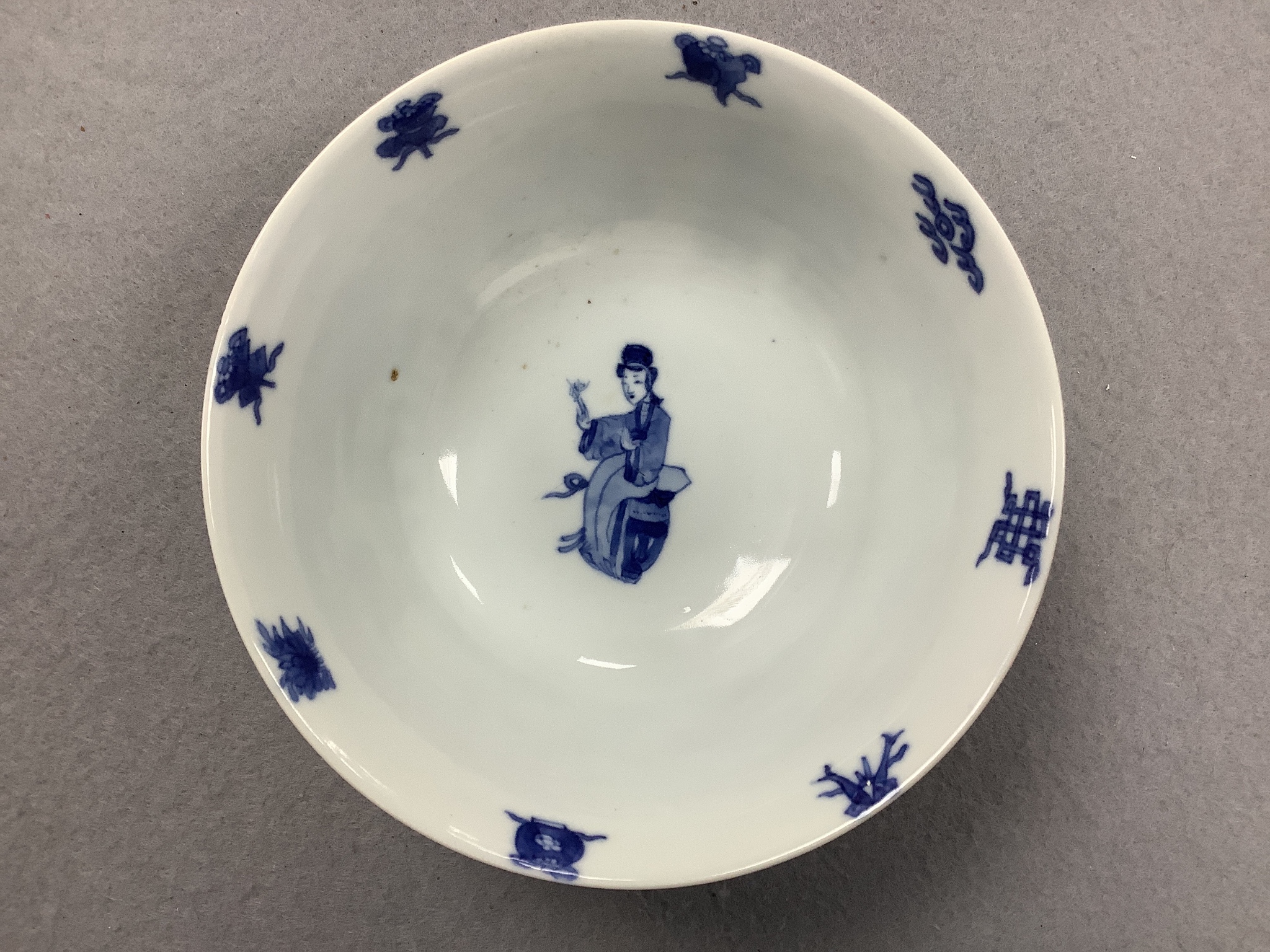 A Chinese blue and white ‘ladies’ bowl, Kangxi period, 15.5cm diameter, wood stand